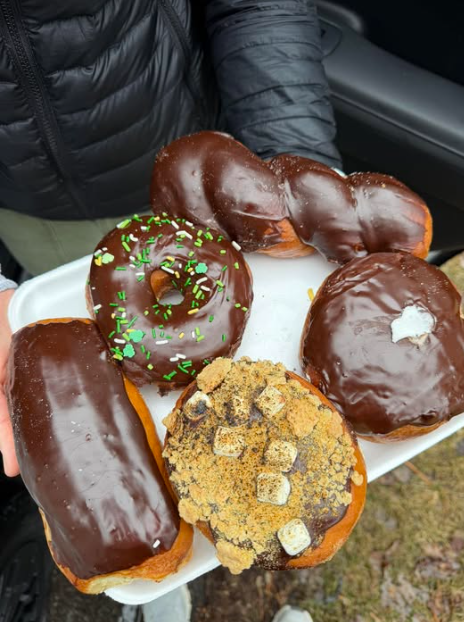 Chocolate-frosted long johns and doughnuts on a tray