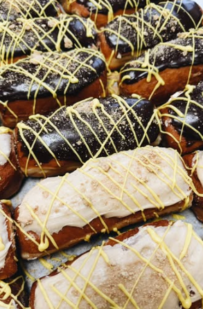 Chocolate long johns drizzled with golden icing