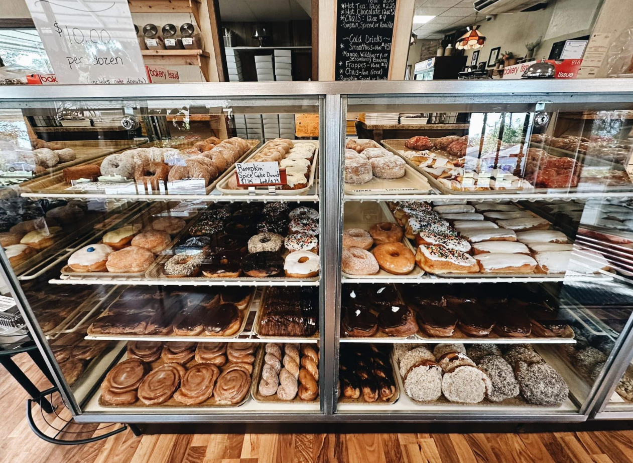 Old-fashioned glass display cases filled with doughnuts and pastries